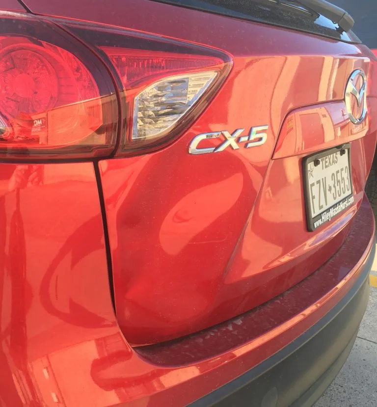 Red SUV before dent repair